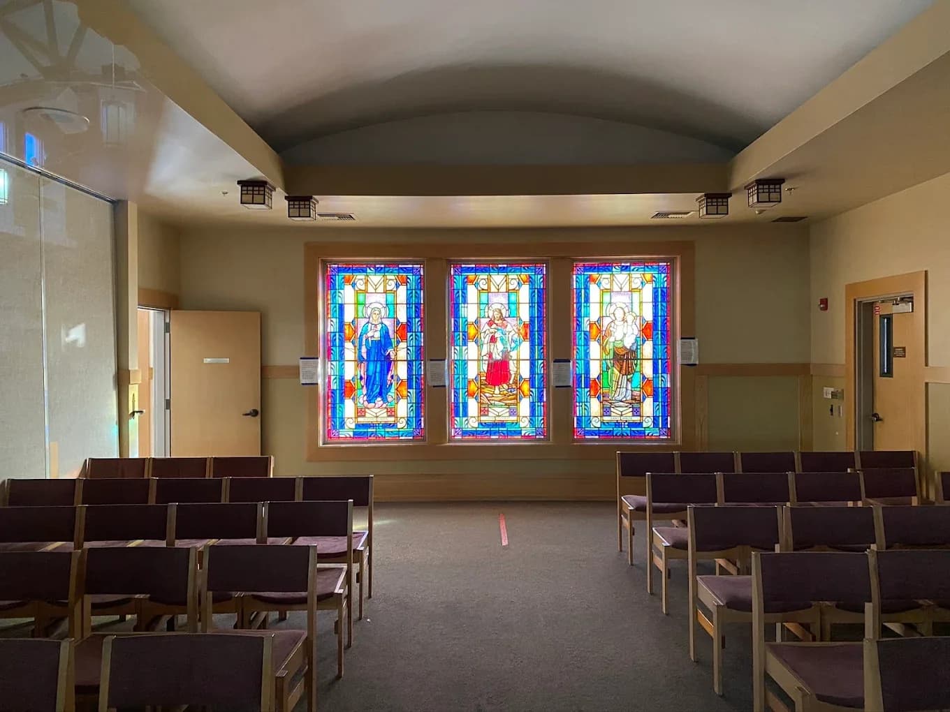 Sanctuary stained glass triptych at the front of a worship space