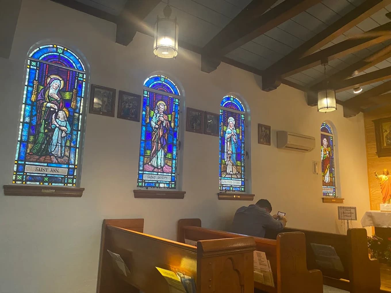 Church stained glass windows inside a sanctuary prepared for cleaning and maintenance